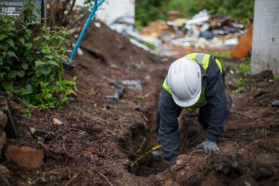 Plumbers digging pipe lines