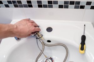 Plumber Installing a Basin tap
